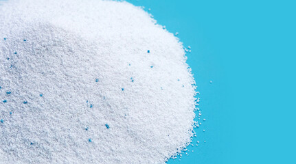 Detergent powder on blue background. Laundry concept.