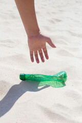 Fototapeta na wymiar Hand man picking plastic bottle waste cleaning on the beach