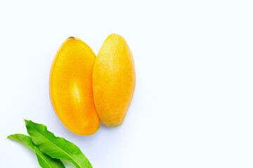 Tropical fruit, Mango with green leaves on white background. Top view