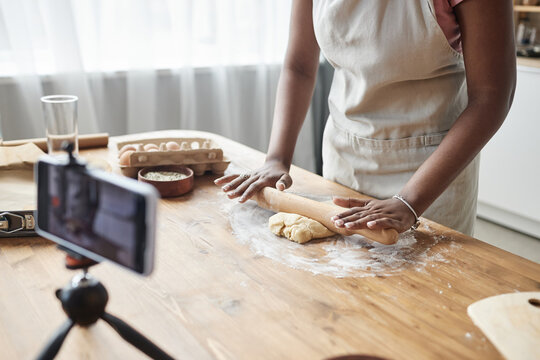 Black woman baking homemade pastry recording video or livestream - Powered by Adobe