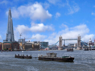 Barge in the Thames River in London, looking west toward Tower Bridge