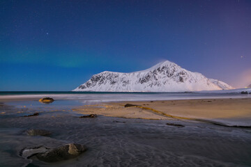 Fabulous winter scenery on Skagsanden beach at night with Northern lights