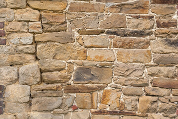 texture of rough masonry yellow rough bricks and cement between them, stone wall