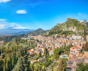 Fototapeta na wymiar Awesome view of Taormina resorts and Etna volcano mount.