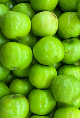 Green apples at a market stand