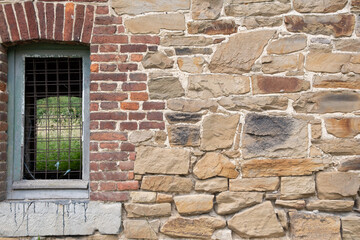 texture of rough masonry yellow rough bricks and cement between them, stone wall
