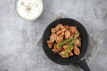 Greek gyros in a frying pan on a gray background