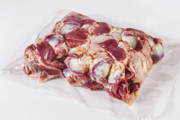 frozen turkey or poultry meat in vacuum packaging on a white background