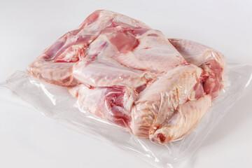 frozen turkey or poultry meat in vacuum packaging on a white background