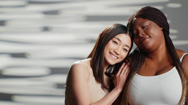 Diverse women showing body positivity and acceptance, group of people with different body types and skintones. Plus size and skinny models being natural and cheerful on camera.