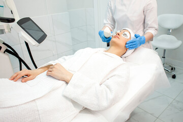 woman patient lies in a modern cosmetology clinic on a facial skin care procedure