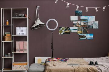 Teenagers room interior with hobbie items on maroon wall