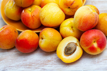 Group of fresh sweet apricot fruits on wooden table