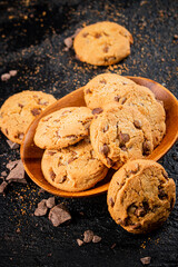 Wooden plate with cookies and pieces of milk chocolate. 