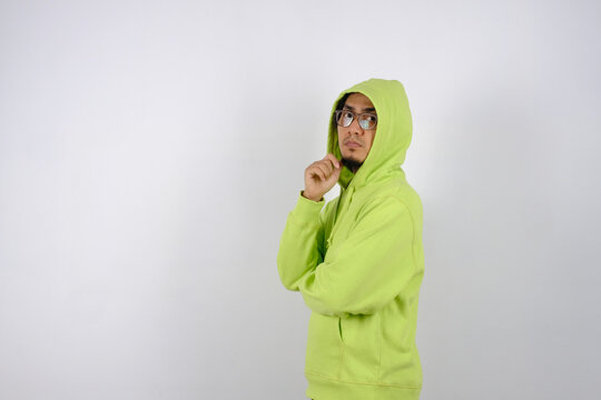 A Man With Glasses And Green Hoodie Sweater Posing To Camera