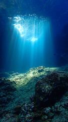 Fototapeta na wymiar Artistic underwater photo of magic rays of sunlight inside a cave