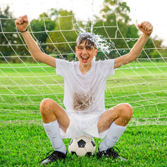 Youth male soccer player cooling off after a long hot game