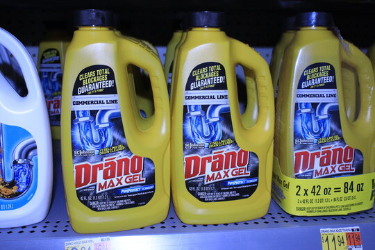 Drano  drain cleaner on a store shelf in plastic bottles.