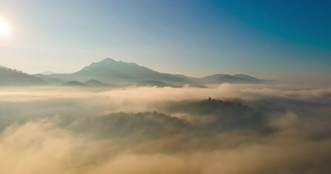 Amazing Sea mist around the mountains with Doi Luk San peak in the background with sunrise at Mae Hong Son province unseen Thailand.Aerial view Motion Time lapse with dolly in and panning drone camera