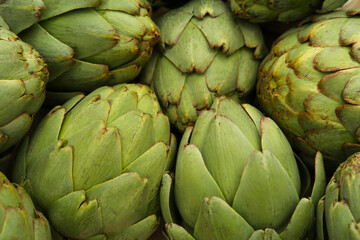 Fototapeta premium Many fresh raw artichokes as background, top view
