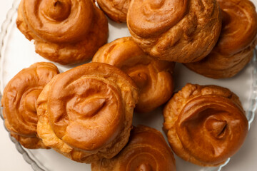 Delicious profiteroles on white table, top view