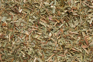 Aromatic dried lemongrass as background, top view