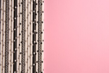 Many paper drinking straws on pink background, flat lay. Space for text
