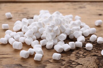 Fototapeta na wymiar Delicious white marshmallows on wooden table, closeup
