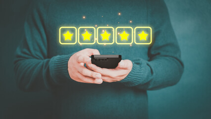 Man's hand using a smartphone and give five star symbol to increase rating of product and service concept, Customer service experience, testimonial and business satisfaction survey.