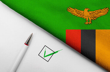 pencil, flag of Zambia and check mark on paper sheet
