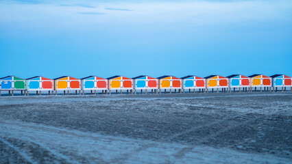 Wildwood New Jersey NJ ocean at night with colorful beach storage on sand landscape - obrazy, fototapety, plakaty