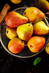 Ripe pears in a colander. 