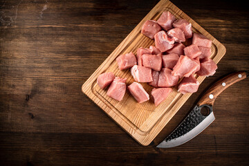 Pieces of raw pork on a cutting board.