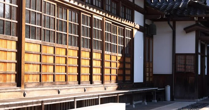 Slow pan across traditional Japanese sliding doors in morning sun