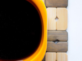 Orange coffee mug on a stand. Very close-up