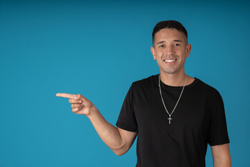 Fototapeta premium Young man pointing to the right