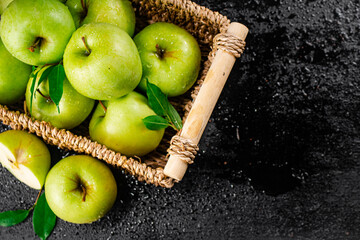 Fresh green apples in a basket. 
