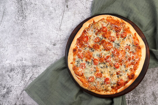 Homemade Blue Cheese And Cherry Tomatoes Pizza On A Round Wooden Cutting Board On A Dark Grey Background. Top View, Flat Lay.