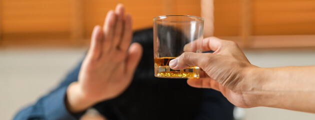 Alcoholism, sad depressed asian young man refuse, push alcoholic beverage glass, drink whiskey,...
