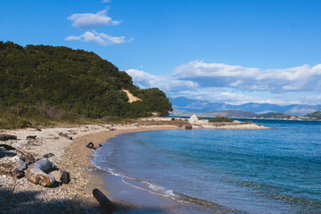 Fototapeta premium View of Erimitis coast landscape near Kassiopi and Agios Stefanos village, Corfu island, Kerkyra, Greece, with hiking trail path, forest and beach in a summer sunny day
