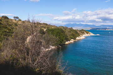 View of Erimitis coast landscape near Kassiopi and Agios Stefanos village, Corfu island, Kerkyra, Greece, with hiking trail path, forest and beach in a summer sunny day