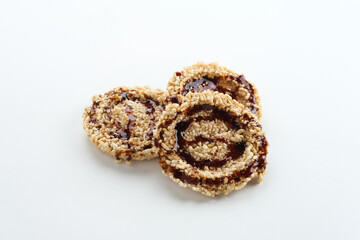 Rice crackers (intip madu or rengginang) with brown sugar on white background. Savory, sweet and crunchy.
