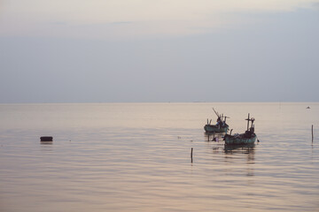 Obraz premium fishing boats sailing in the middle of the sea