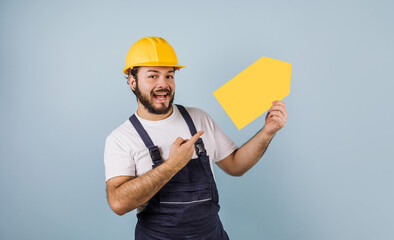 Hispanic bearded young man Professional worker with hard helmet in Mexico Latin America on blue background