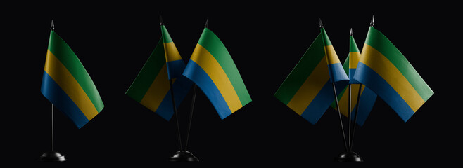 Small national flags of the Gabon on a black background