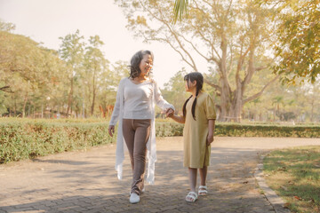Portrait of asia grandmother and grandchildren holiday vacation together in the park in the summer in Southeast Asia Pacific.