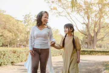 Fototapeta premium Portrait of asia grandmother and grandchildren holiday vacation together in the park in the summer in Southeast Asia Pacific.