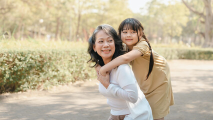 Fototapeta premium Portrait of asia grandmother and grandchildren holiday vacation together in the park in the summer in Southeast Asia Pacific.
