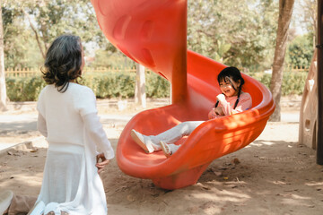 Portrait of asia grandmother and grandchildren holiday vacation together in the park in the summer in Southeast Asia Pacific. playground