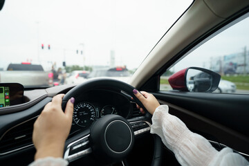 Woman driving car. girl feeling happy to drive holding steering wheel and looking on road.